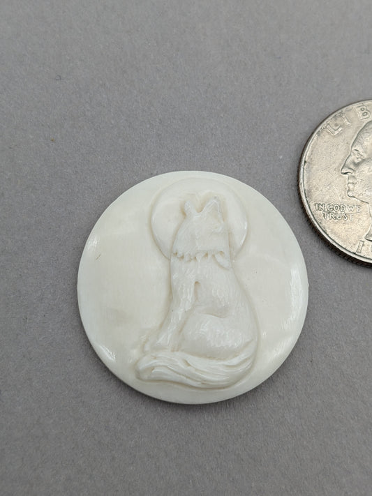 Carved bovine bone cabochon wolf howling at the moon