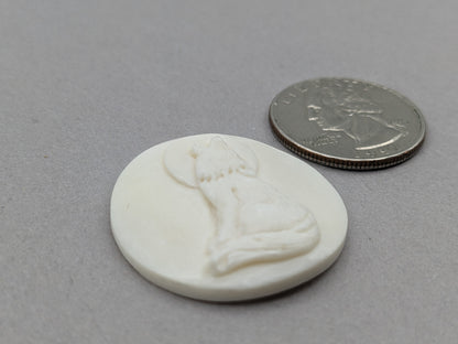 Carved bovine bone cabochon wolf howling at the moon